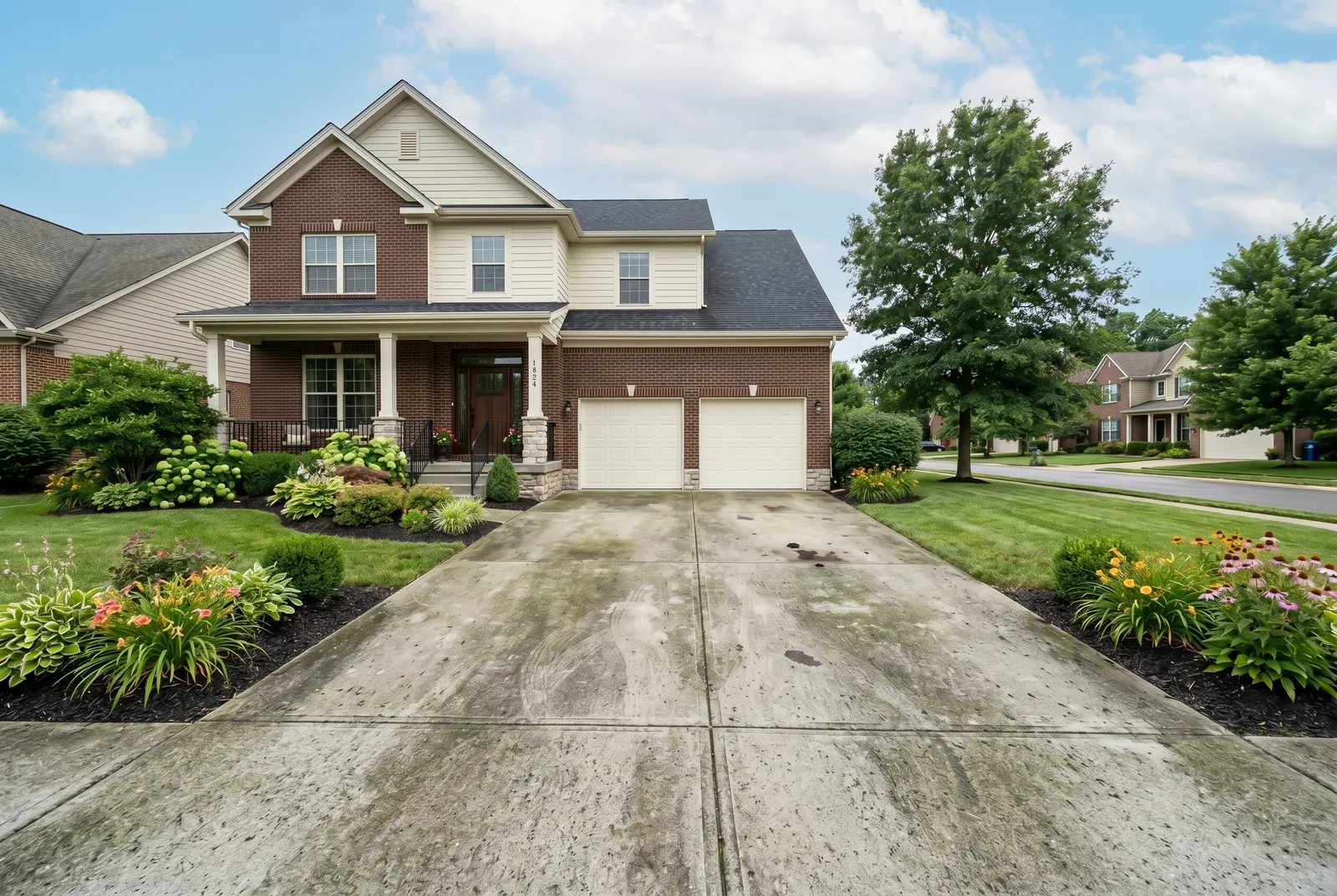 Concrete driveway before cleaning in Middletown, KY, algae, tire marks, and oil stains